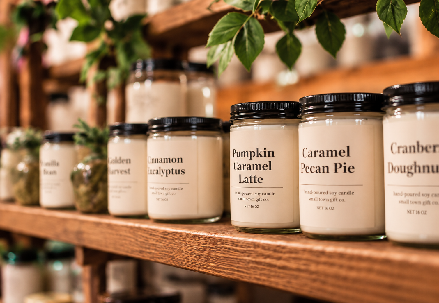 Small Town Gift Co. candles displayed on wooden shelves